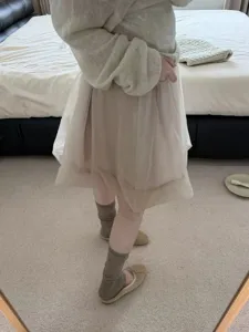 Detail shot of sheer stacked sock covers and stirrup half-sole socks, styled in Korean aesthetic.