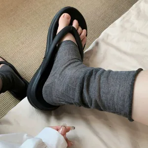 Sheer grey slouch socks and thick-soled thong sandals, breathable summer daily wear.