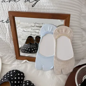 Detail view of tabi split-toe invisible socks in light blue and khaki, perfect for summer.