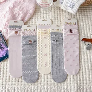 Sweet ruffled mid-tube socks with cute bear embroidery, bow details, and delicate texture.