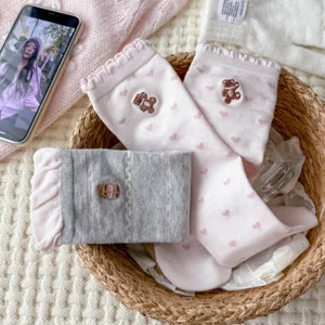 Sweet pink and grey mid-tube socks featuring cute bear embroidery and heart prints with ruffles.