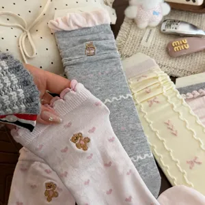 Sweet embroidered bear slouch socks with ruffled cuffs for women, comfortable mid-calf hosiery.