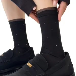 Women black sheer dot socks paired with classic loafers, elegant organza ankle fashion hosiery.