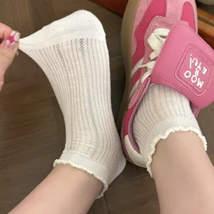 Vue détaillée montrant des chaussettes courtes blanches respirantes avec élastique.