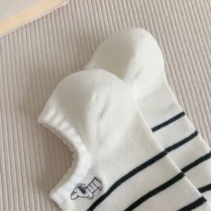 Close-up of cute women's short socks with black and white stripes and puppy embroidery.