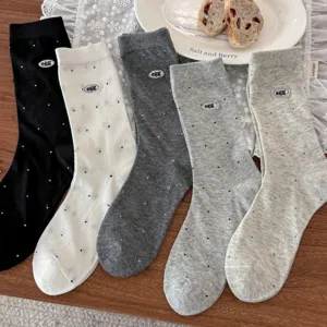 Detailed close-up shot of women's mid-tube socks featuring cute egg embroidery and dots.