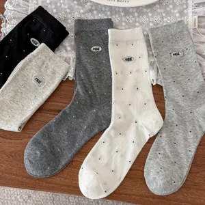 Close-up of cute Japanese style polka dot mid-calf socks with egg embroidery, multi-color.