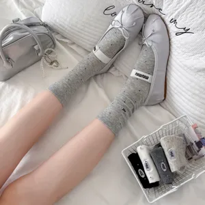 Women's gray polka dot mid tube socks with cute embroidery and stylish ballet flats design.