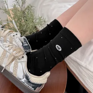 Korean style black mid-tube socks with cute egg embroidery and white polka dot patterns.