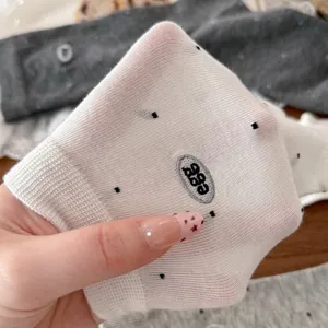 Cute white polka dot knit socks for women, featuring a trendy egg embroidery detail.