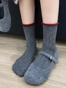 Grey wool blend mid-calf socks with red roll top and felt mary jane shoes for winter.