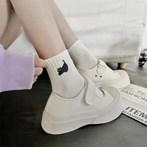 Detailed view of cute cat embroidered white cotton short socks paired with platform canvas shoes.