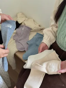 Cozy winter wool blend mid tube socks with cute letter embroidery and rolled cuffs for warmth.
