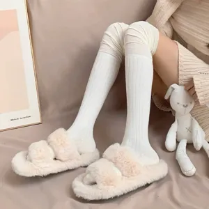 Comfortable white over-the-knee ribbed socks paired with cozy plush slippers for daily wear.