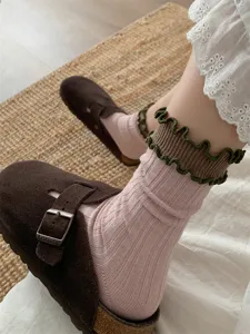 Detailed shot of Japanese retro sweet contrast color ruffled cuff mid-tube cotton socks.