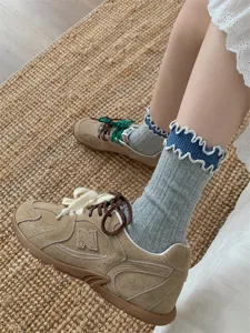 Detailed view of Japanese retro style ruffled cotton mid-tube socks with casual shoes.