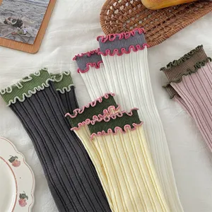Japanese vintage style women ruffle mid-tube socks with contrast color ribbed design.
