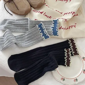 Detailed view of Japanese retro contrast color ruffle cotton mid-tube socks with double rib.