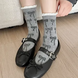 Close-up detail of Korean style bow print mid-calf socks with contrast ruffles worn.