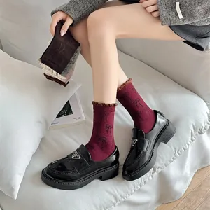 Korean ins style women mid-calf socks featuring allover bow print and contrast color ribbed cuffs.