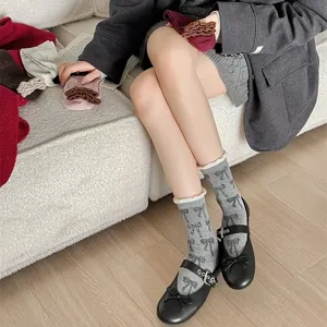 Korean style sweet bow printed mid tube socks with contrasting color bubble hem design for women.