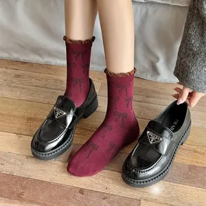 Korean ins style bow pattern mid-tube socks featuring contrasting ribbed bubble cuffs.