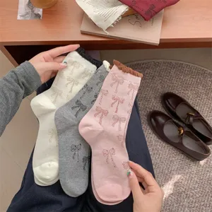 Korean ins style women mid-tube socks with cute bow patterns and contrast color ruffles.
