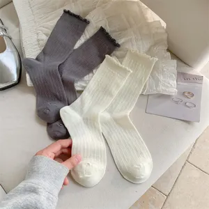 Ballet style ruffle ribbed mid-tube socks detail shot, soft cotton breathable design.
