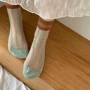 Breathable mesh mid-tube socks detail with vertical stripes and color-block ribbed cuffs.
