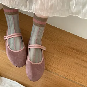 Close-up detail of women's sheer mesh striped mid-calf socks paired with cute Mary Jane shoes.