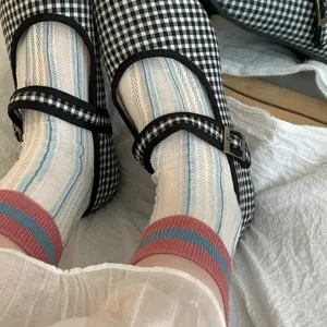Close-up of women's breathable mesh mid-tube socks with vertical stripes and colorblock.