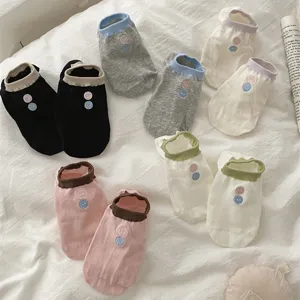 Detailed top view of womens short ankle socks in various colors with cute button embroidery.