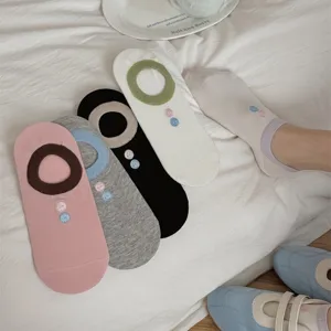 Detail view of women low-cut breathable mesh socks with cute button embroidery and anti-slip.