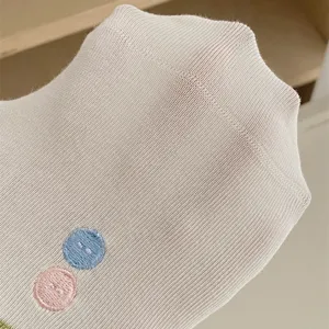 Close-up detail of women breathable mesh short socks with cute button embroidery.