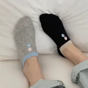 Close-up detail of women's short boat socks with cute button embroidery and contrast cuffs.