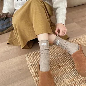 Detailed shot of Japanese style rolled edge ribbed socks with cute egg label design.