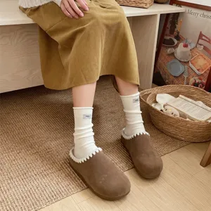 Japanese style solid color slouch wool socks detail view showing ribbed texture and cute tag.