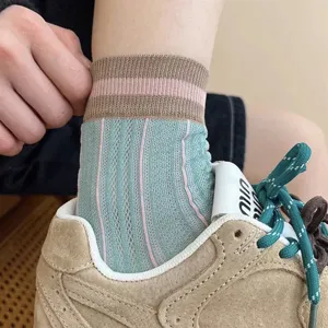 Stylish women's mid-calf socks featuring vertical stripes and breathable mesh design for summer wear.