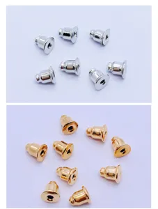 Gold and silver metal bullet earring backs close up detail view, essential DIY jewelry making parts.