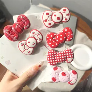 Vintage red bow hair clips set, cute cherry polka dot hairpins for sweet daily styling wear.