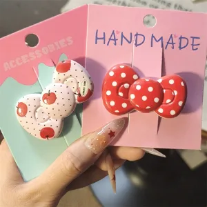 Cute red polka dot bow hair clips detailed view, sweet style fringe side clips for girls daily wear.
