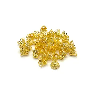 Detailed close-up of gold filigree bead caps for DIY jewelry making and hair accessories.