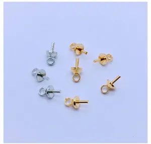 Detail shot of metal eye pins and jewelry findings, showing electroplated surface and structure.