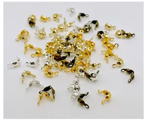 Detail view of DIY metal electroplated clamshell bead tips and cord clasp jewelry findings.