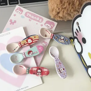 Detailed close-up of cute ceramic spoons featuring adorable puppy prints and colorful stripes.
