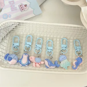 Cute ocean animal keychains set, cartoon penguin and whale design for bags decor.