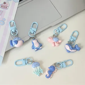 Cute ocean animal keychains detail shot featuring cute cartoon backpack pendants in blue.