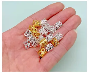 Detailed view of metal dreadlocks hair rings, gold and silver color, braid cuffs for DIY hair.