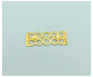 Gold metal hair braid ring DIY accessory detail close-up for stylish dreadlocks styling.