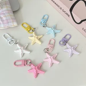 Colorful resin starfish keychain set, cute ocean charm pendant for bags and keys daily.